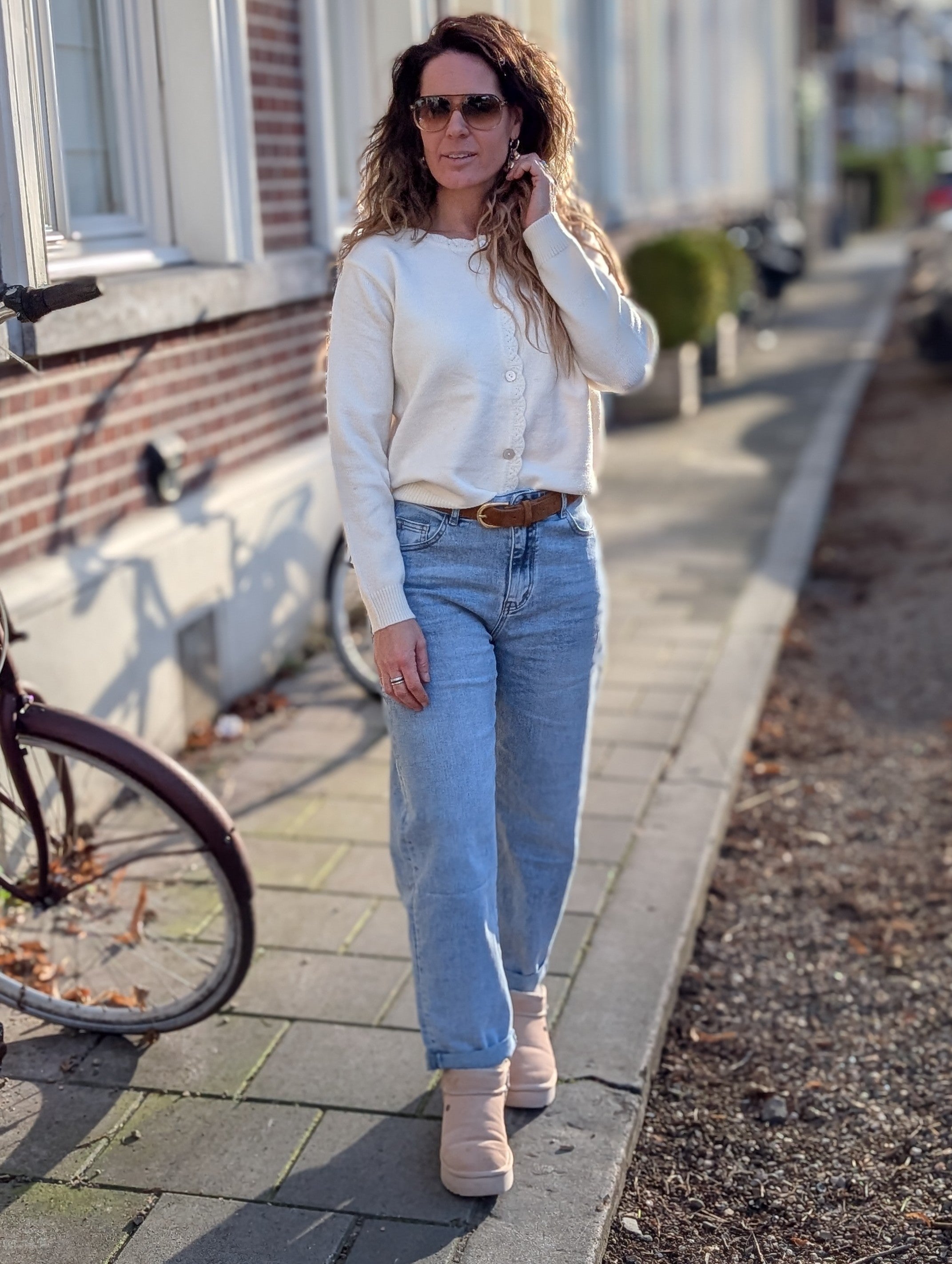 Wit gebreid vestje, met sierlijke rand en kantdetails