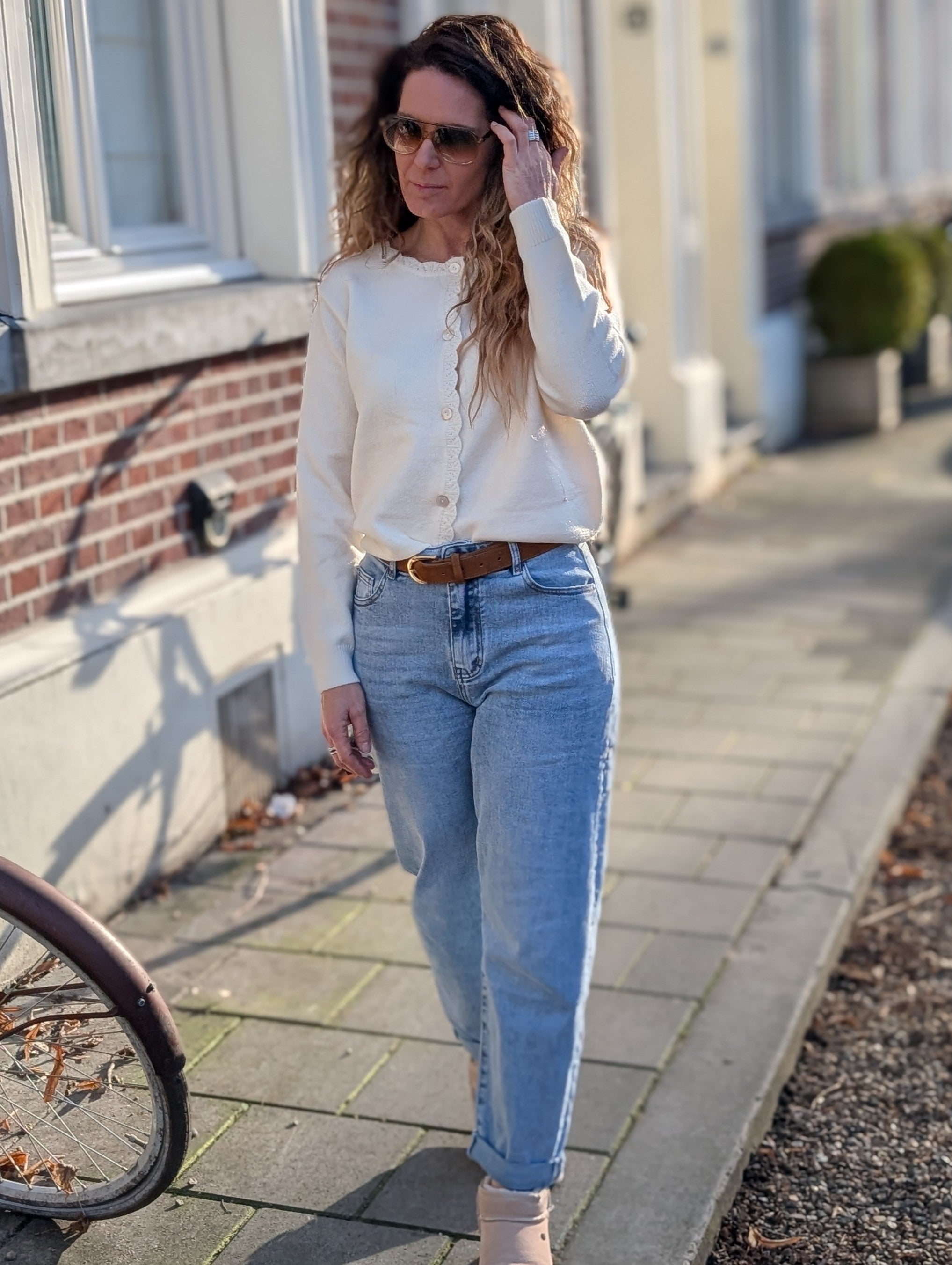 Wit gebreid vestje, met sierlijke rand en kantdetails